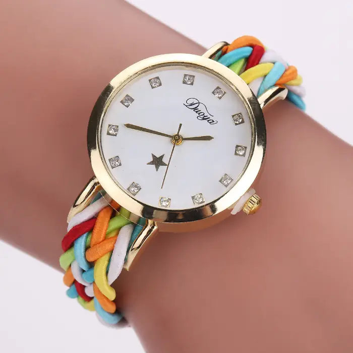 Women's watch with a gold case, white dial, and colorful braided rope band.