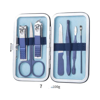 Compact navy blue manicure set with scissors, nail clippers, and grooming tools in hinged metal case with blue interior