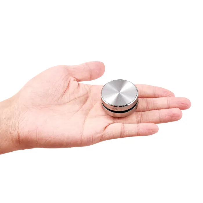 Silver DuraMOBI speaker shown in palm for size reference, demonstrating its compact portable design