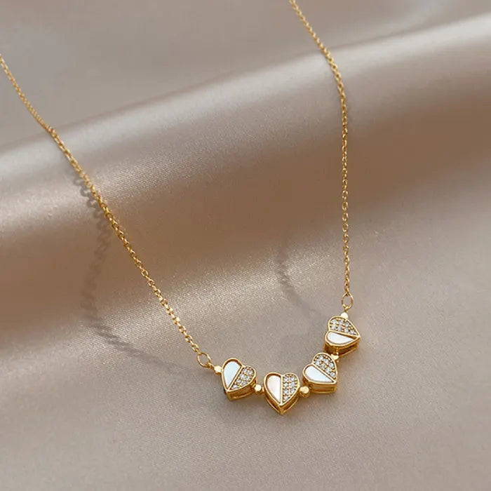 Convertible Heart Necklace featuring row of gold heart charms with enamel and crystals