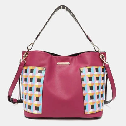 Multi-wear pink leather purse with adjustable shoulder strap, geometric print accents, and silver hardware details