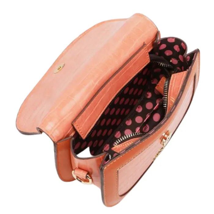 Open coral leather bag showing black and pink polka dot lining with multiple compartments and zippered pocket