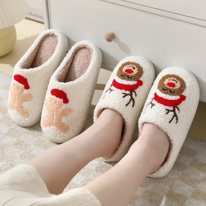 Cozy holiday slippers with reindeer and gingerbread man designs, shown worn for a festive vibe.