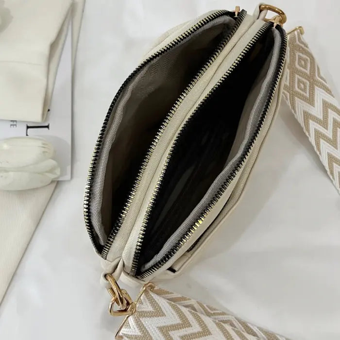 Cream bag interior showcasing multiple zipped compartments for organized storage and daily essentials.