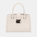 Cream leather designer handbag with polished silver hardware and structured silhouette in classic tote style
