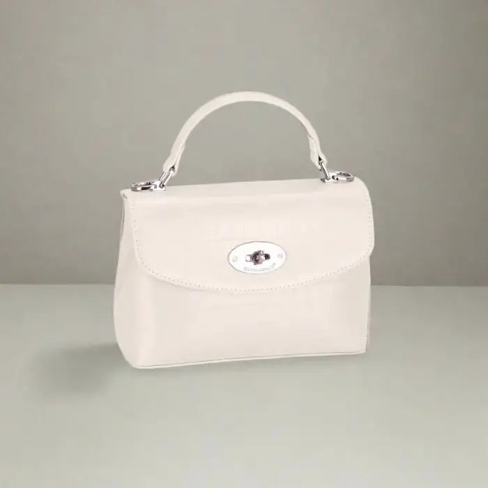 Cream white crocodile-textured leather handbag with silver clasp, perfect for minimalistic fashion lovers.