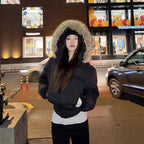 Cropped bomber jacket with fur hood styled at night, winter bomber jacket offering insulation, comfort and urban appeal