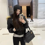 Cropped bomber jacket with fur hood styled indoors mirror selfie, padded winter bomber showing comfort and modern fit