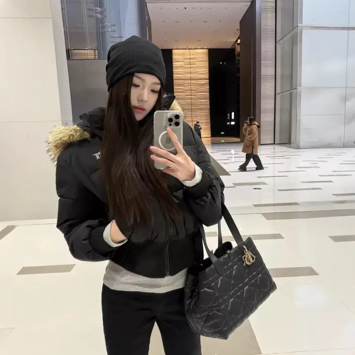 Cropped bomber jacket with fur hood styled indoors mirror selfie, padded winter bomber showing comfort and modern fit