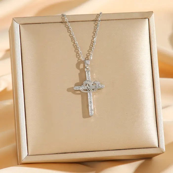 Cross Heart Necklace Set silver pendant displayed on gift box, featuring sparkling crystal cross and intertwined heart centerpiece