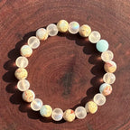 Crystal healing bracelet arranged in sunlight highlighting jasper and frosted beads, supporting grounding energy and clarity focus