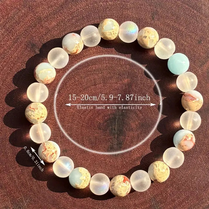 Crystal healing bracelet with luminous frosted beads and jasper stones shown on white background, offering calm energy and renewal