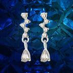 crystal teardrop dangle earrings in silver displayed on deep blue gemstone backdrop, sparkling rhinestones creating an elegant luxury appeal
