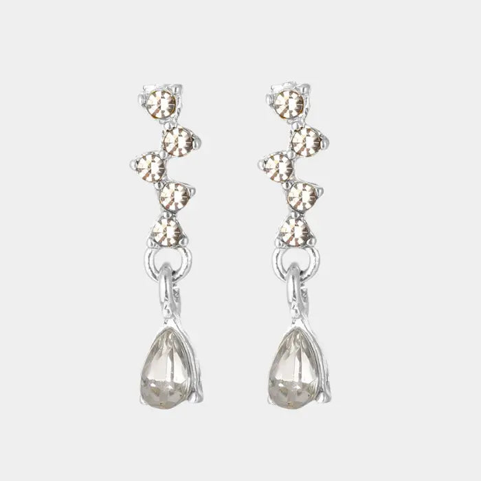 crystal teardrop dangle earrings in silver isolated on white background, delicate rhinestone detailing for chic lightweight jewelry styling