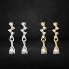crystal teardrop dangle earrings in silver and gold displayed against dark backdrop, sparkling rhinestone set offering elegant lightweight jewelry options