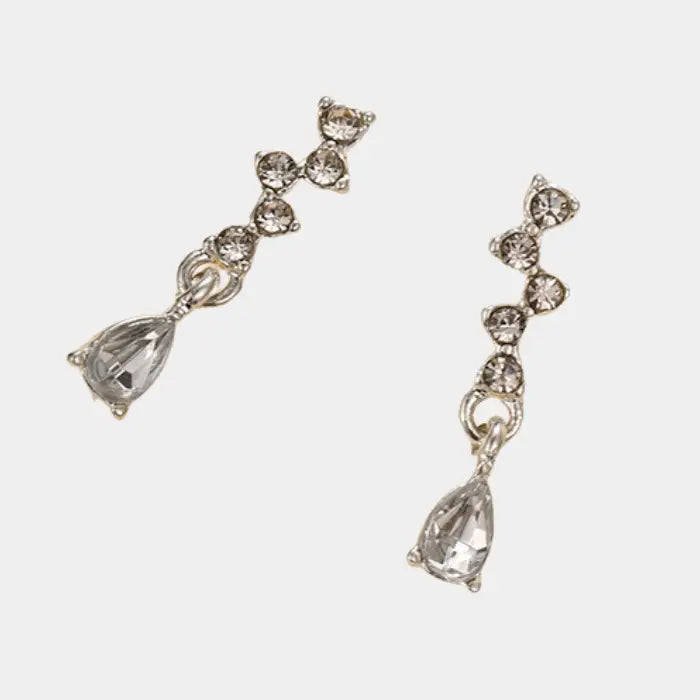 crystal teardrop dangle earrings in silver shown on white background, detailed rhinestone design for elegant minimal fashion accessories