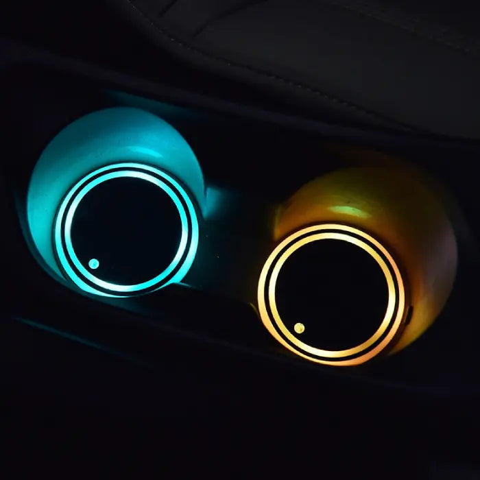 Custom coasters with turquoise and yellow LED lighting installed in vehicle cup holders