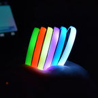 Custom coasters with LED illumination shown in car cup holders with pink and blue glow
