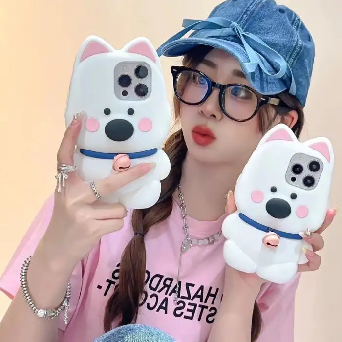cute animal phone case with a 3D white dog design, held by a person wearing glasses and a denim cap.