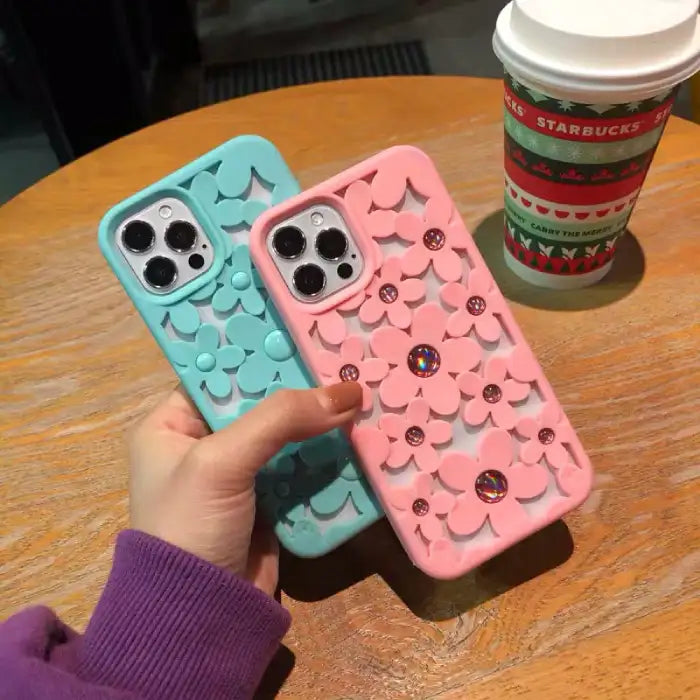 Cute floral iPhone case in coral color with 3D flower cutout design and matching glossy raised button centers