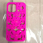 Cute floral iPhone case in vibrant hot pink color with daisy flower cutout pattern and glossy button centers