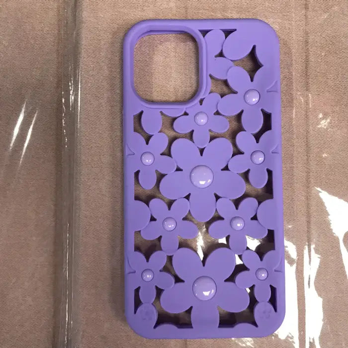 Cute floral iPhone case in purple with 3D flower cutout design featuring daisy pattern and raised glossy centers