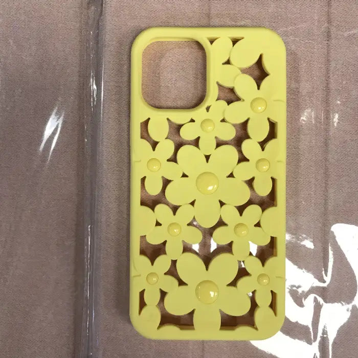 Cute floral iPhone case in soft yellow with 3D daisy cutout pattern featuring matching glossy button centers