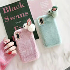 cute fluffy iPhone cases in pink and mint green with plush material and 3D bunny ears.