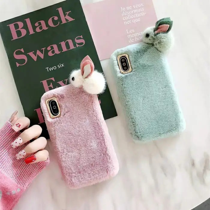 cute fluffy iPhone cases in pink and mint green with plush material and 3D bunny ears.