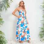 Cute summer dress showcasing side view of blue tropical foliage print with thin straps and flowing maxi length