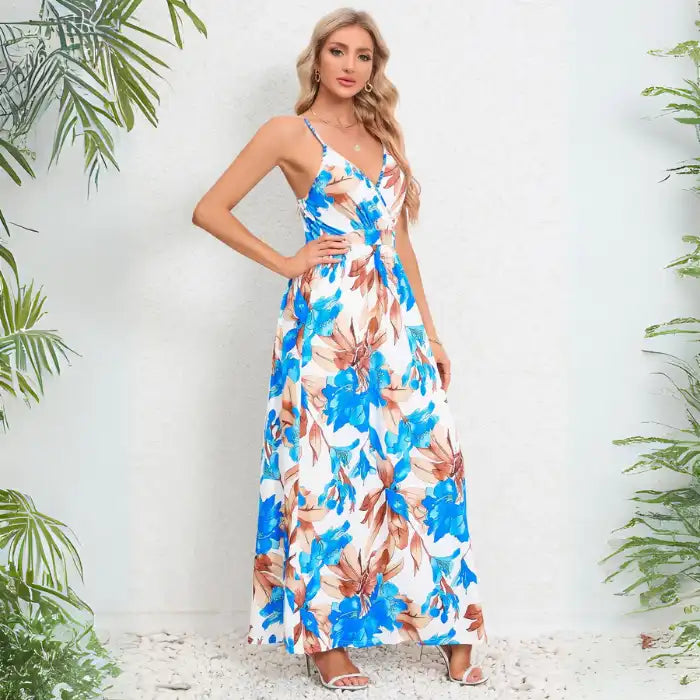 Cute summer dress showcasing side view of blue tropical foliage print with thin straps and flowing maxi length