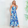 Cute summer dress featuring vibrant blue tropical leaf design with v-neck wrap bodice and spaghetti straps for beach vacations