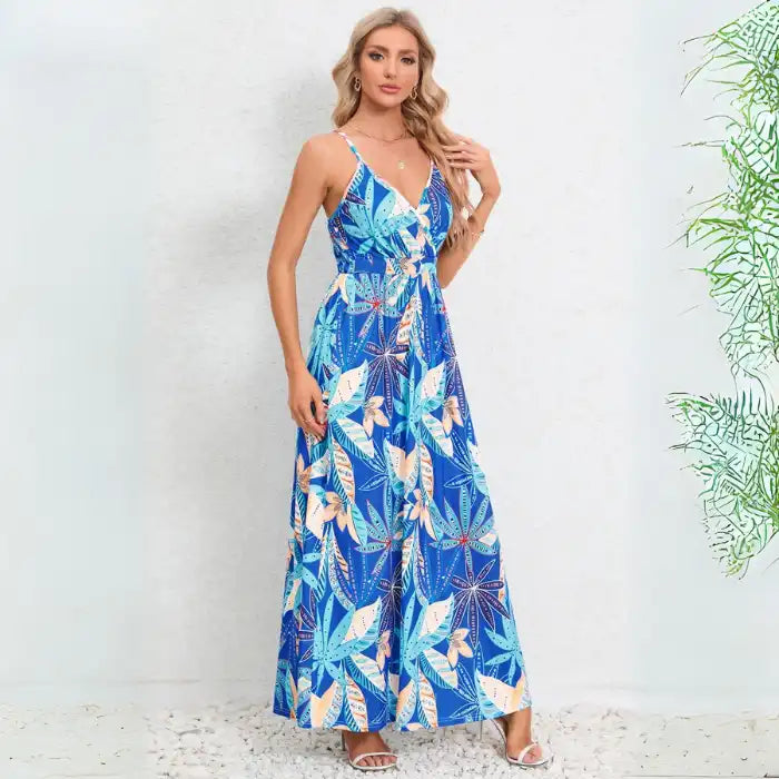 Cute summer dress featuring vibrant blue tropical leaf design with v-neck wrap bodice and spaghetti straps for beach vacations