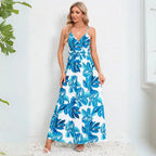 Cute summer dress in vibrant blue with tropical leaf motif, v-neck design and maxi length perfect for warm weather occasions