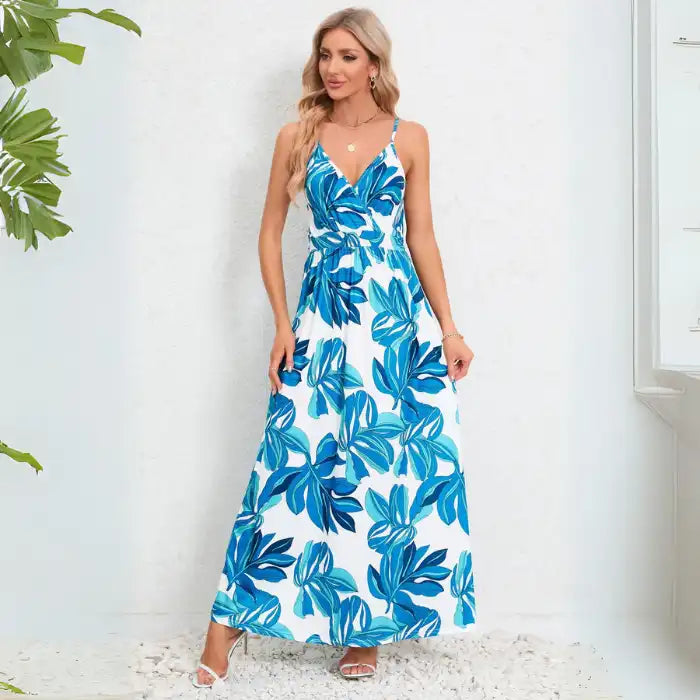 Cute summer dress in vibrant blue with tropical leaf motif, v-neck design and maxi length perfect for warm weather occasions
