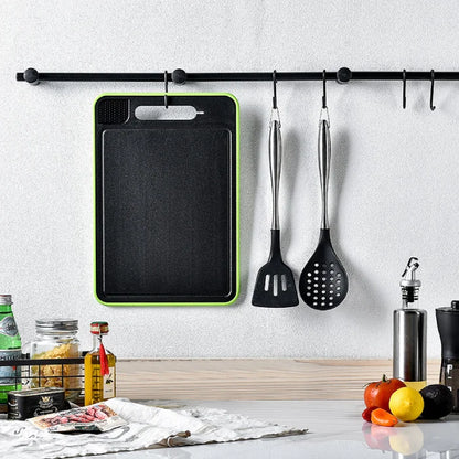 Stylish kitchen with cutting board hanging on wall among cooking utensils.