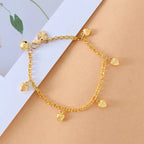 dainty gold heart chain bracelet with small dangling charms displayed on soft background, offering an elegant minimalist gift-ready style