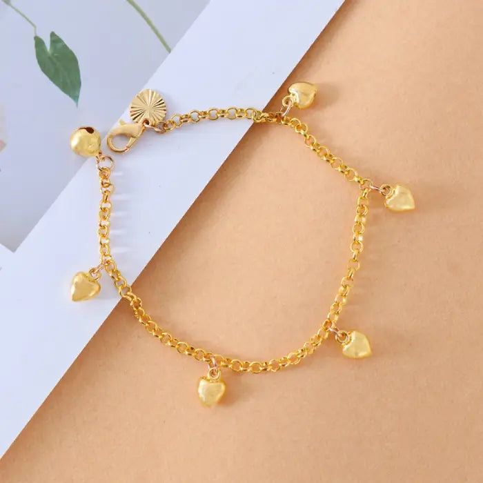 dainty gold heart chain bracelet displayed neatly with multiple dangling charms, offering a romantic delicate style perfect for gifting