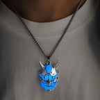 Dare-Devil Necklace blue glow-in-dark demon pendant shown worn on silver chain over white shirt