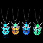 Dare-Devil Necklace glowing demon mask pendants in blue, orange, green, and aqua under black background