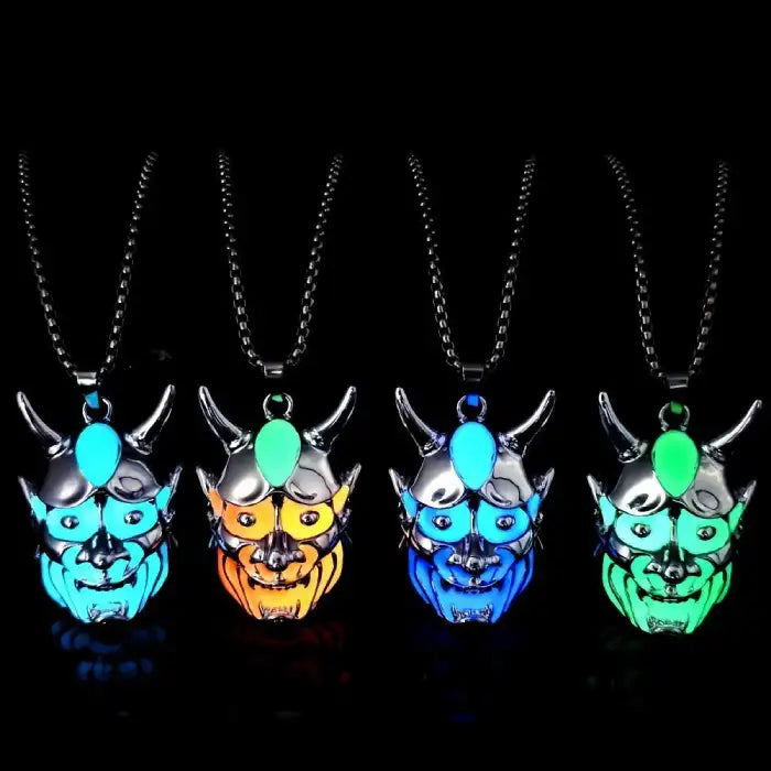 Dare-Devil Necklace glowing demon mask pendants in blue, orange, green, and aqua under black background