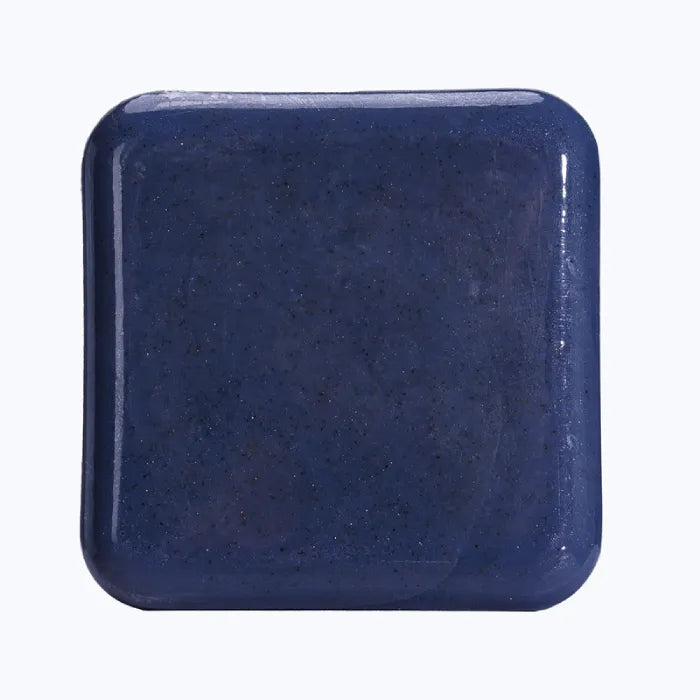 Deep blue exfoliating soap bar for men, enriched with natural ingredients.