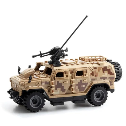 Desert camouflage military toy truck with antennas and a modular roof gun attachment.