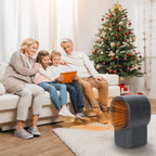 Desktop electric heater glowing orange near family during holidays beside Christmas tree.