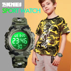 Digital wristwatch in green camouflage shown on kid wearing matching outfit in bright setting