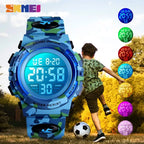 Digital wristwatch with glowing blue screen worn by kid kicking a soccer ball outdoors