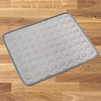 dog cooling mat in light gray color with darker border showing quilted circular pattern design for hot weather relief