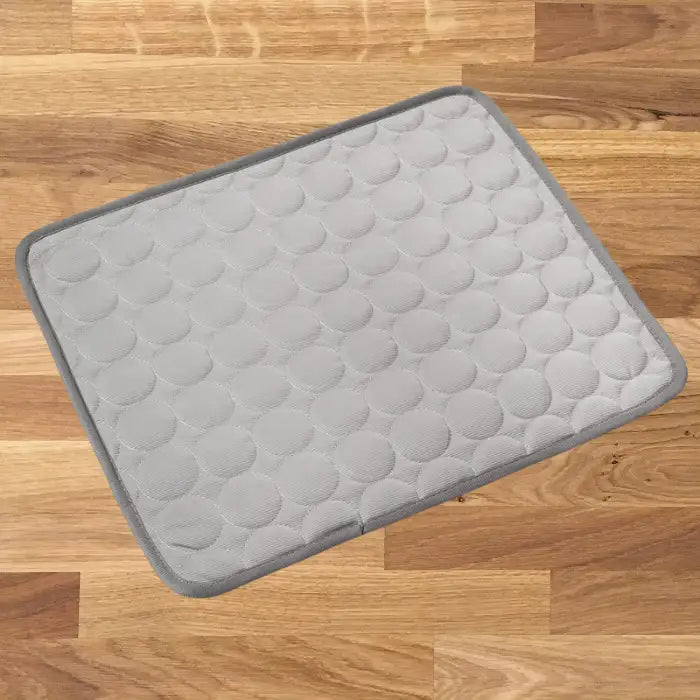 dog cooling mat in light gray color with darker border showing quilted circular pattern design for hot weather relief