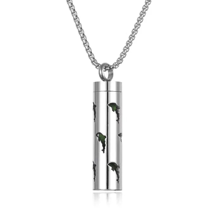 Dolphin cutout aromatherapy pendant with green accents, crafted from stainless steel for essential oils.