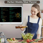 Drawing tablet used as a weekly meal planner on kitchen wall beside woman preparing a salad.